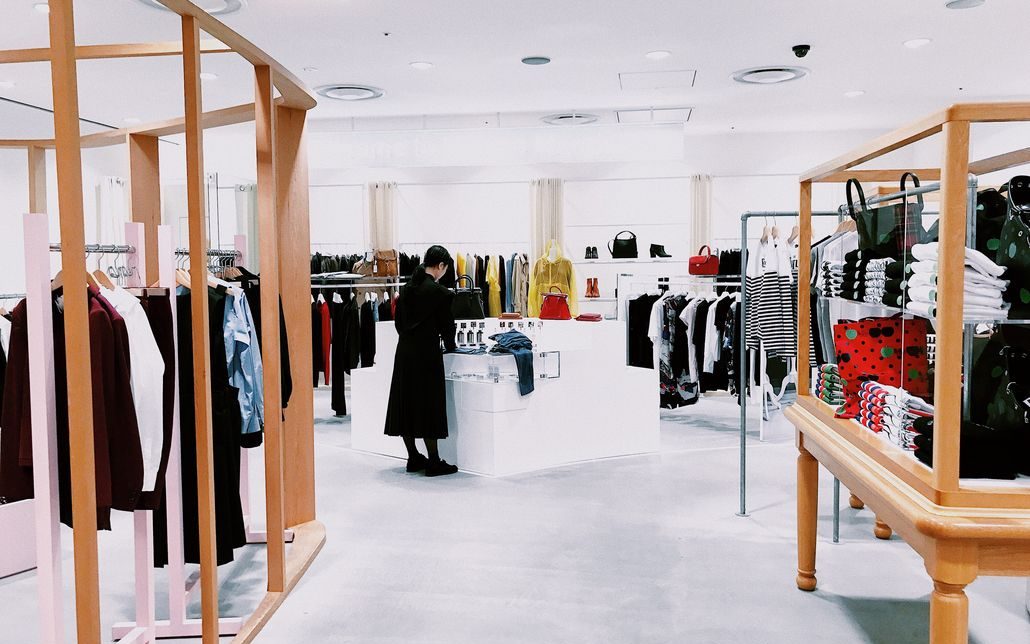 a clothing store in japan with a lady at the counter, meant to represent the concept of gemba and how it can be used in marketing